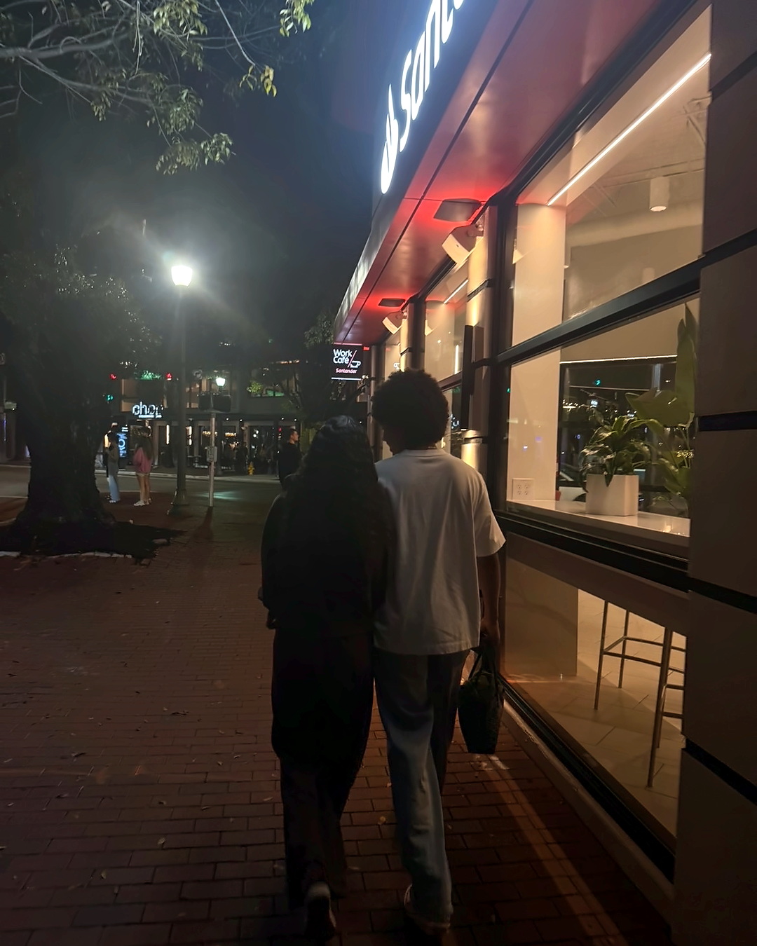 Walking together, photographed from behind.