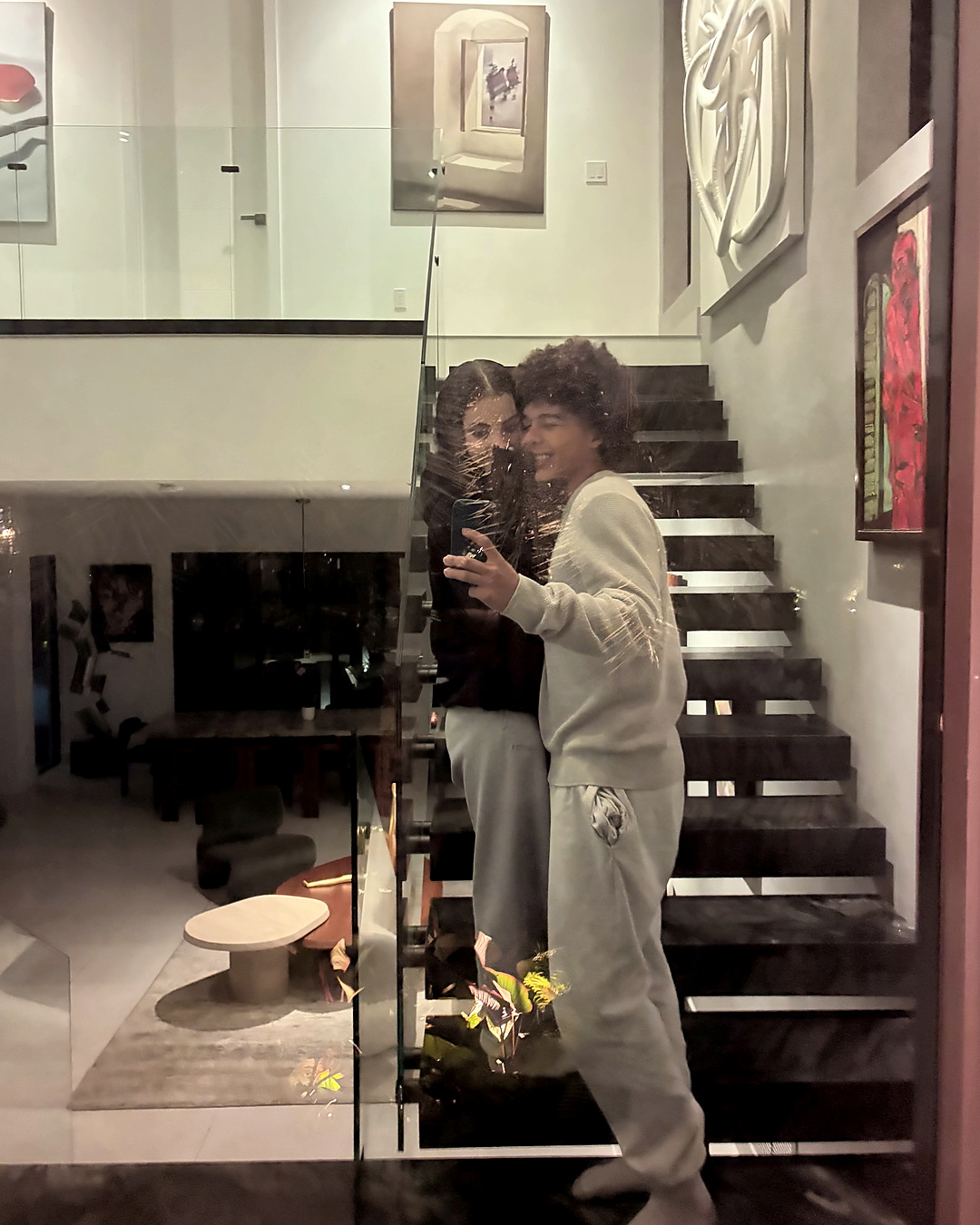 In a glass reflection on the staircase.