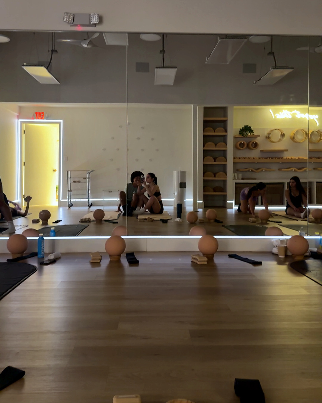 A pilates studio mirror selfie.
